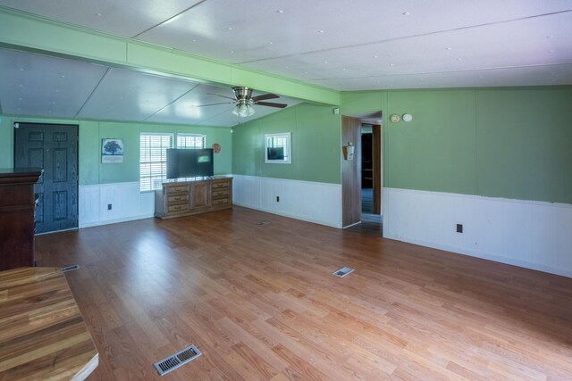 272 Walker Rd, Rossville, GA 30741 - unfurnished living room featuring a wainscoted wall, ceiling fan, wood finished floors, and vaulted ceiling