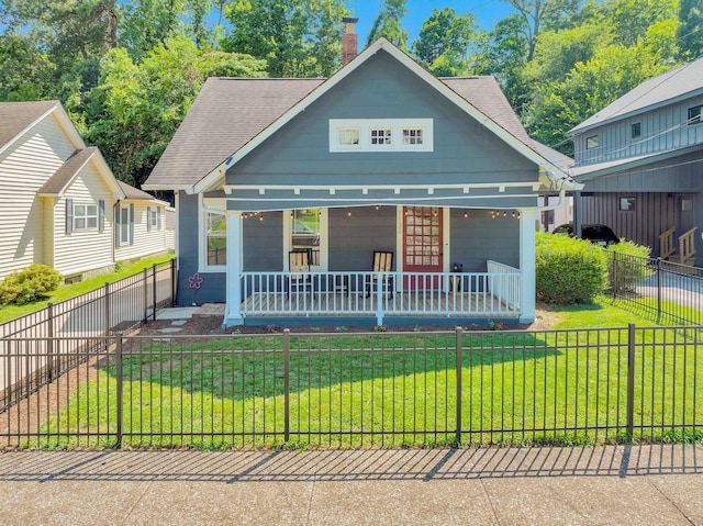 1132 Dartmouth St, Chattanooga, TN 37405 - view of front of property featuring a porch, a chimney, a shingled roof, and a fenced front yard