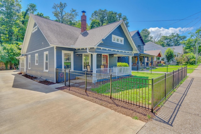 1132 Dartmouth St, Chattanooga, TN 37405 - view of front facade with a porch, roof with shingles, a chimney, and a fenced front yard