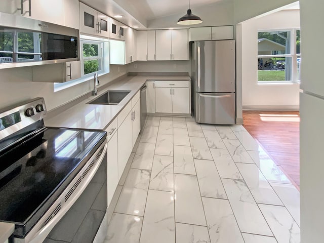 1116 Magnolia St, Lafayette, GA 30728 - kitchen featuring appliances with stainless steel finishes, white cabinetry, healthy amount of natural light, and light marble finish floors