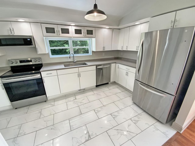 1116 Magnolia St, Lafayette, GA 30728 - kitchen with stainless steel appliances, white cabinetry, light marble finish flooring, and hanging light fixtures