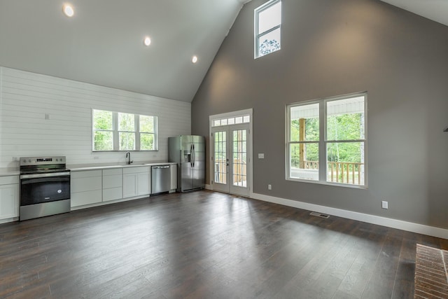 483 W Reed Rd, Lafayette, GA 30728 - kitchen with appliances with stainless steel finishes, high vaulted ceiling, light countertops, white cabinetry, and healthy amount of natural light