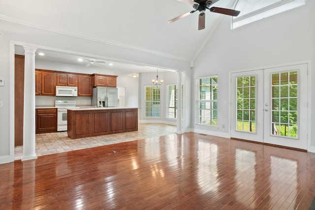 1502 Brock Cir, Ringgold, GA 30736 - unfurnished living room with ceiling fan, plenty of natural light, light wood-type flooring, decorative columns, and high vaulted ceiling