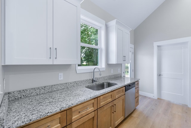 307 Cavender St, Lafayette, GA 30728 - kitchen with stainless steel dishwasher, lofted ceiling, light wood-style flooring, light stone countertops, and white cabinetry