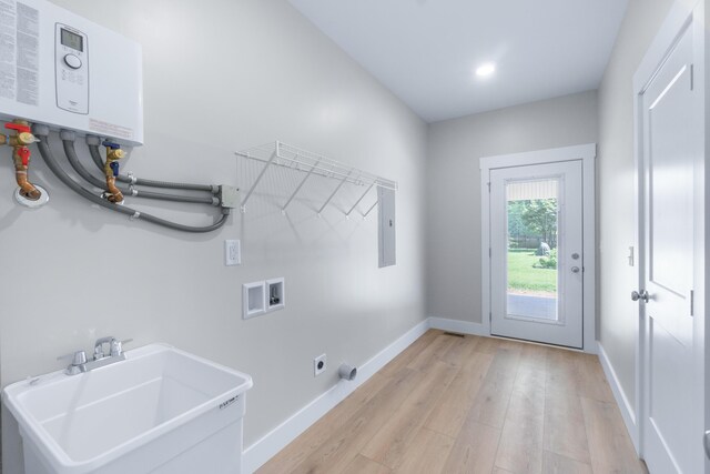 307 Cavender St, Lafayette, GA 30728 - washroom featuring washer hookup, light wood-style floors, water heater, electric dryer hookup, and electric panel