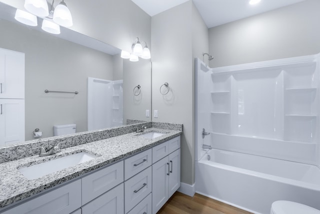 307 Cavender St, Lafayette, GA 30728 - bathroom featuring wood finished floors, double vanity, and bathtub / shower combination