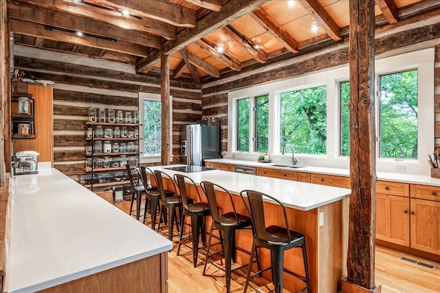 1908 Clear Brooks Dr, Signal Mountain, TN 37377 - kitchen featuring stainless steel refrigerator with ice dispenser, healthy amount of natural light, light wood-style floors, a wood ceiling with exposed beams, and wooden walls
