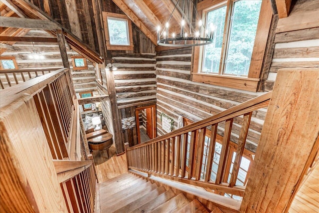 1908 Clear Brooks Dr, Signal Mountain, TN 37377 - staircase with a chandelier, wood walls, and vaulted ceiling