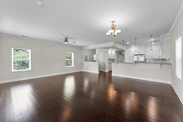 1120 Valentine Cir, Chattanooga, TN 37405 - unfurnished living room featuring dark wood finished floors, a chandelier, a ceiling fan, and ornamental molding
