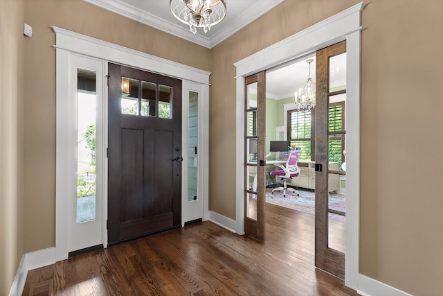 9795 Trestle Cir, Ooltewah, TN 37363 - entrance foyer with a chandelier, ornamental molding, and dark wood finished floors