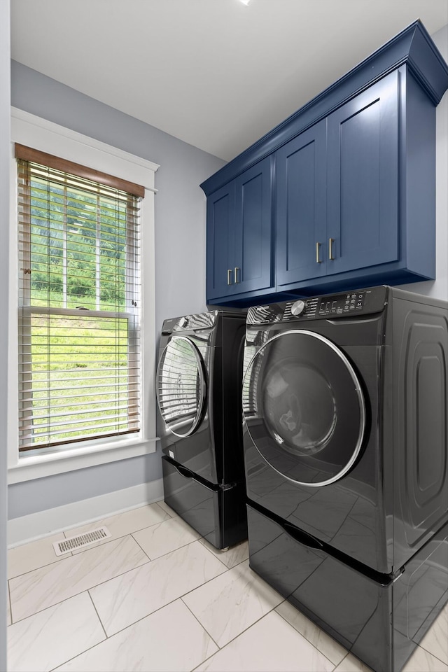 9795 Trestle Cir, Ooltewah, TN 37363 - washroom with washing machine and clothes dryer, cabinet space, and light marble finish floors