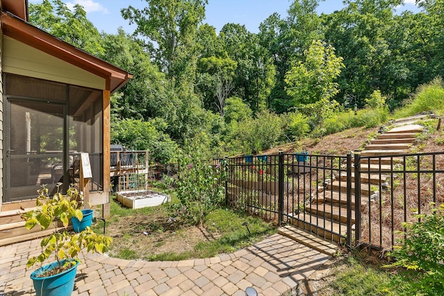 9795 Trestle Cir, Ooltewah, TN 37363 - view of yard featuring a sunroom, a garden, and view of wooded area