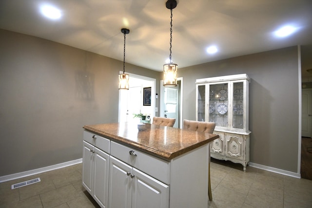 268 Lawrence Dr, Rossville, GA 30741 - kitchen with a kitchen island, tile patterned floors, pendant lighting, recessed lighting, and white cabinetry