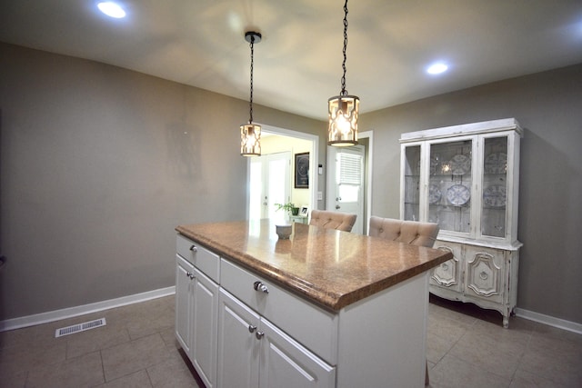 268 Lawrence Dr, Rossville, GA 30741 - kitchen featuring tile patterned floors, a center island, recessed lighting, white cabinets, and pendant lighting