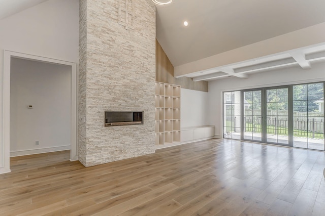 807 Judd Ter, Dalton, GA 30720 - unfurnished living room featuring high vaulted ceiling, a stone fireplace, wood finished floors, and beamed ceiling