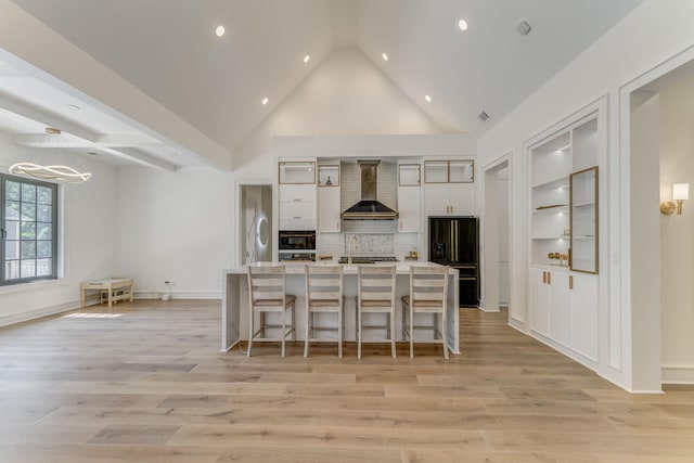 807 Judd Ter, Dalton, GA 30720 - kitchen with wall chimney exhaust hood, black fridge with ice dispenser, a breakfast bar, light wood-style floors, and a chandelier