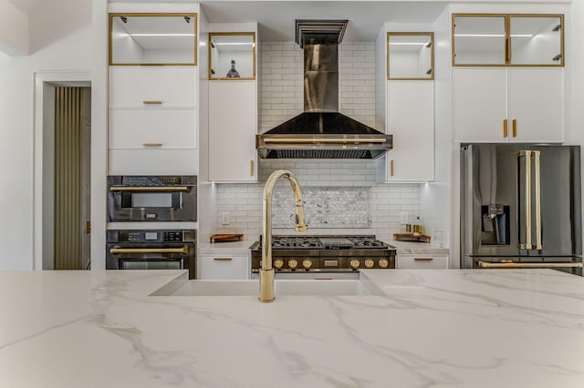 807 Judd Ter, Dalton, GA 30720 - kitchen with stainless steel fridge, wall chimney range hood, white cabinetry, and tasteful backsplash