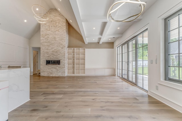 807 Judd Ter, Dalton, GA 30720 - unfurnished living room with healthy amount of natural light, light wood-style floors, recessed lighting, beamed ceiling, and a stone fireplace
