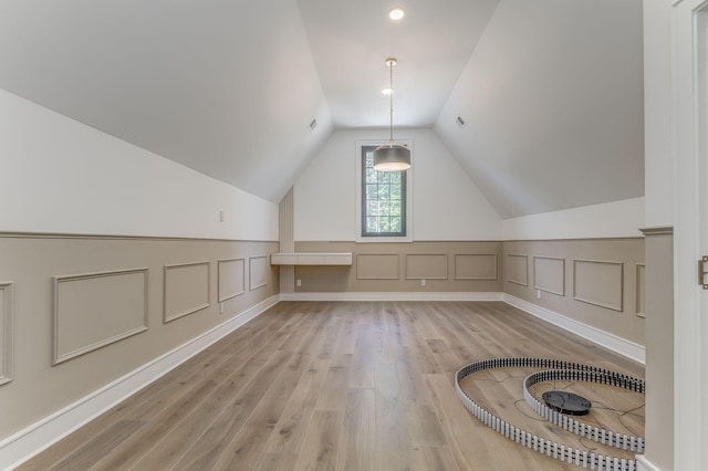 807 Judd Ter, Dalton, GA 30720 - additional living space with light wood-style floors, lofted ceiling, a decorative wall, and wainscoting