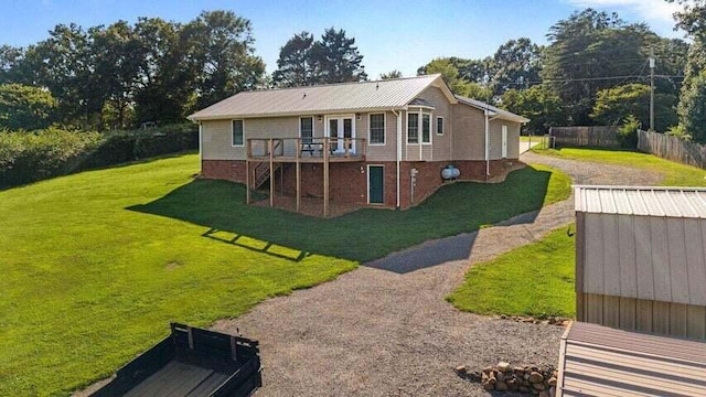 346 Thomas Rd, Benton, TN 37307 - back of house with a deck, stairs, a storage unit, dirt driveway, and a metal roof