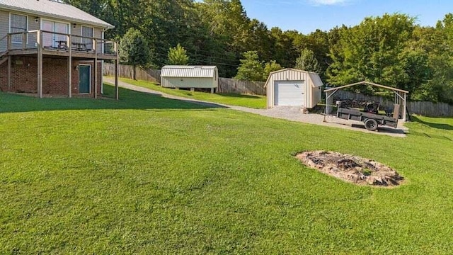 346 Thomas Rd, Benton, TN 37307 - view of yard featuring a shed, a garage, and a deck