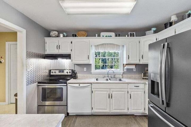 346 Thomas Rd, Benton, TN 37307 - kitchen featuring stainless steel appliances, under cabinet range hood, white cabinetry, and light countertops