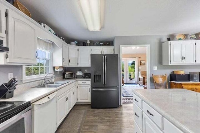 346 Thomas Rd, Benton, TN 37307 - kitchen featuring refrigerator with ice dispenser, white dishwasher, dark wood-type flooring, and white cabinets