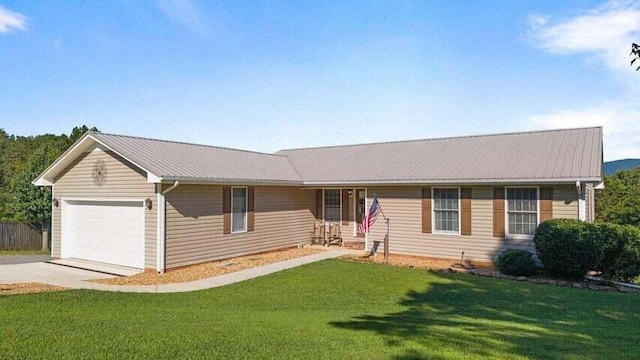 346 Thomas Rd, Benton, TN 37307 - single story home featuring an attached garage, concrete driveway, a front lawn, and a metal roof