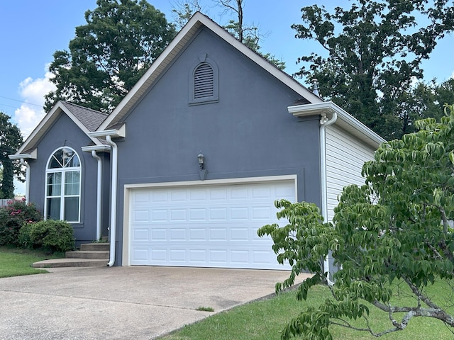 7901 Hamilton Mill Dr, Chattanooga, TN 37421 - view of property exterior with driveway, stucco siding, and a garage