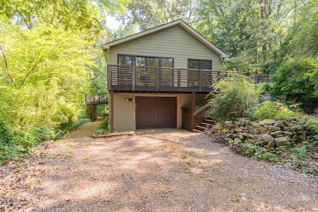 4205 Seneca Ave, Chattanooga, TN 37409 - chalet / cabin featuring a garage, dirt driveway, stairs, and a wooden deck