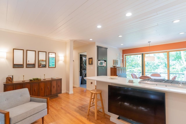 4205 Seneca Ave, Chattanooga, TN 37409 - kitchen with stacked washer and clothes dryer, recessed lighting, light wood finished floors, wood ceiling, and a kitchen bar