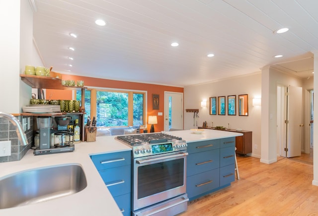 4205 Seneca Ave, Chattanooga, TN 37409 - kitchen featuring stainless steel range with gas cooktop, recessed lighting, light countertops, blue cabinetry, and light wood-style floors