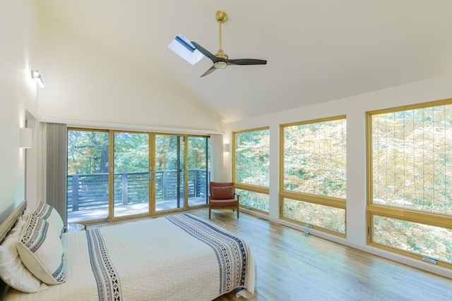 4205 Seneca Ave, Chattanooga, TN 37409 - bedroom featuring access to exterior, high vaulted ceiling, wood finished floors, a ceiling fan, and a skylight