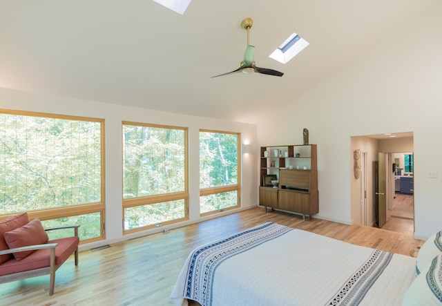4205 Seneca Ave, Chattanooga, TN 37409 - bedroom with a skylight, multiple windows, light wood-style flooring, high vaulted ceiling, and a ceiling fan