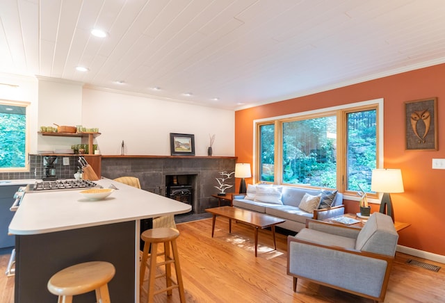 4205 Seneca Ave, Chattanooga, TN 37409 - living area featuring crown molding, light wood-style floors, recessed lighting, and a wood stove