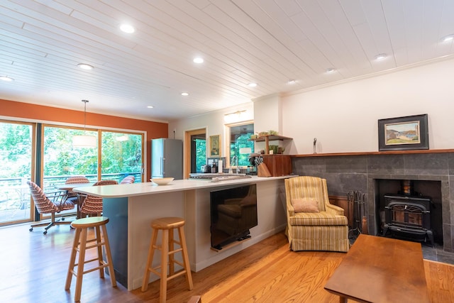 4205 Seneca Ave, Chattanooga, TN 37409 - kitchen with a wood stove, light wood-style floors, recessed lighting, a kitchen bar, and wood ceiling
