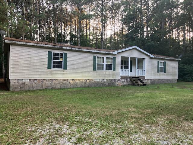 287 E Teems Rd, Ringgold, GA 30736 - manufactured / mobile home featuring covered porch, a front yard, and view of wooded area