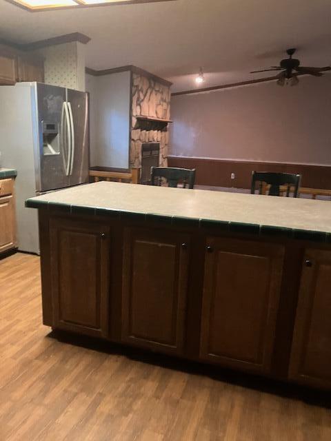 287 E Teems Rd, Ringgold, GA 30736 - kitchen with a ceiling fan, a fireplace, light countertops, and light wood-type flooring