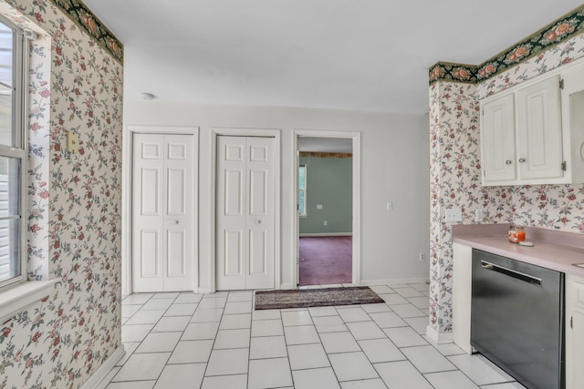 6661 Hickory Trace Cir, Chattanooga, TN 37421 - kitchen featuring dishwashing machine, wallpapered walls, light countertops, light tile patterned floors, and white cabinets