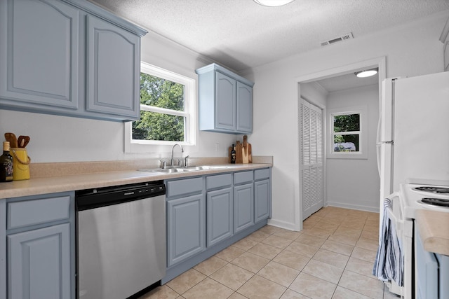 5014 Carolyn Ln, Chattanooga, TN 37411 - kitchen featuring stainless steel dishwasher, white electric range oven, light countertops, plenty of natural light, and a textured ceiling