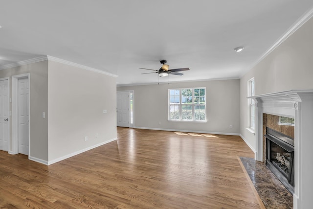 5586 Crooked Creek Dr, Ooltewah, TN 37363 - unfurnished living room featuring a premium fireplace, a ceiling fan, crown molding, and wood finished floors