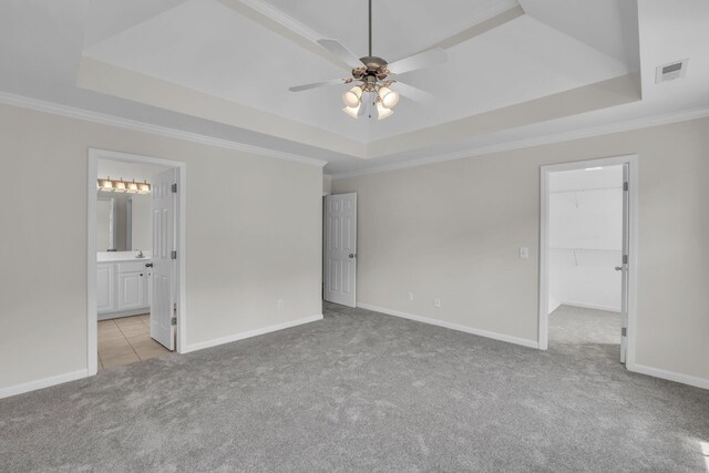 5586 Crooked Creek Dr, Ooltewah, TN 37363 - unfurnished bedroom with a raised ceiling, carpet floors, crown molding, a walk in closet, and ensuite bath