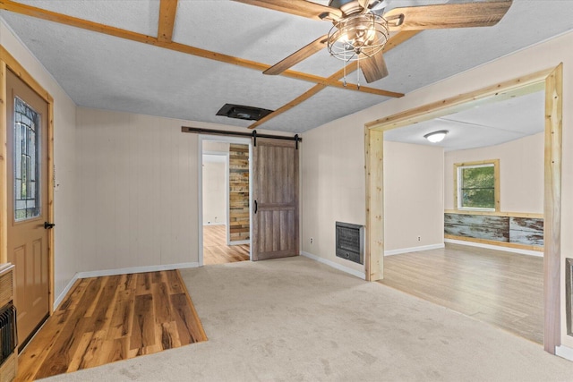4621 Bramblett Dr SE, Dalton, GA 30721 - empty room featuring wood finished floors, a barn door, ceiling fan, and heating unit