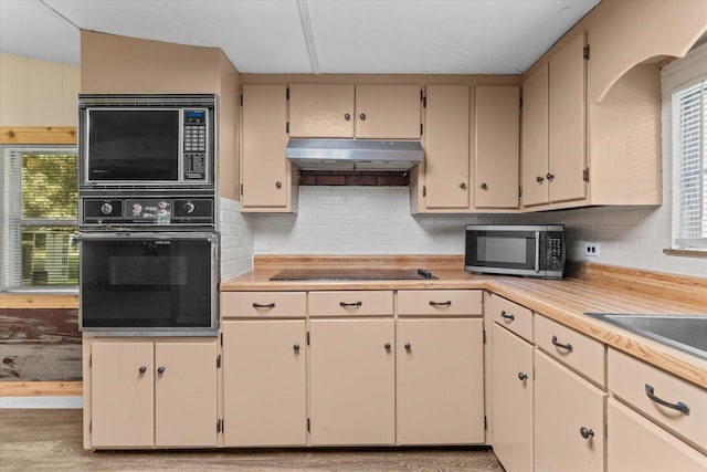 4621 Bramblett Dr SE, Dalton, GA 30721 - kitchen with black appliances, under cabinet range hood, and cream cabinetry