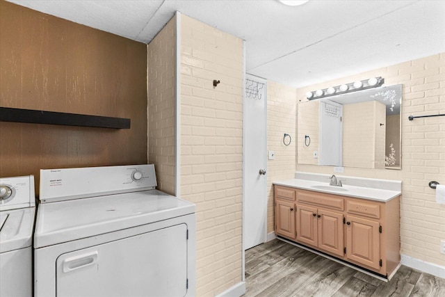 4621 Bramblett Dr SE, Dalton, GA 30721 - laundry room featuring independent washer and dryer, light wood-style floors, and wood walls
