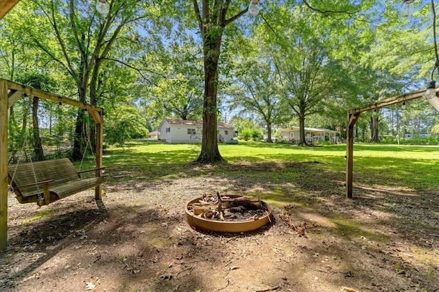 4621 Bramblett Dr SE, Dalton, GA 30721 - view of grassy yard with an outdoor fire pit