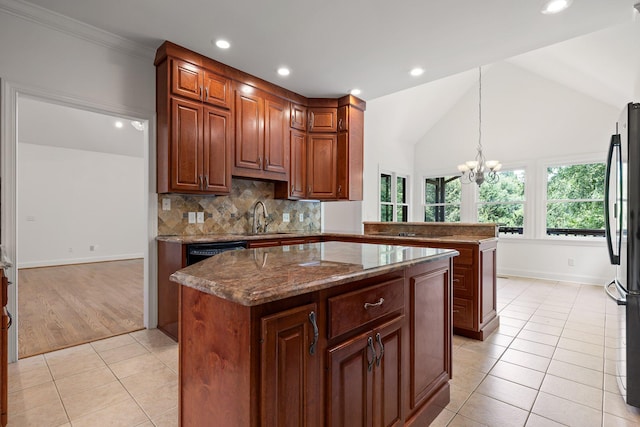9539 Shadow Crossing Ln, Chattanooga, TN 37421 - kitchen featuring freestanding refrigerator, light tile patterned floors, recessed lighting, a center island, and tasteful backsplash