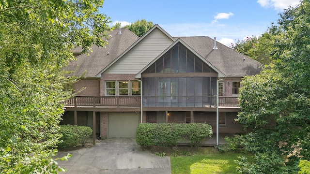 9539 Shadow Crossing Ln, Chattanooga, TN 37421 - back of property featuring brick siding, a garage, driveway, and roof with shingles