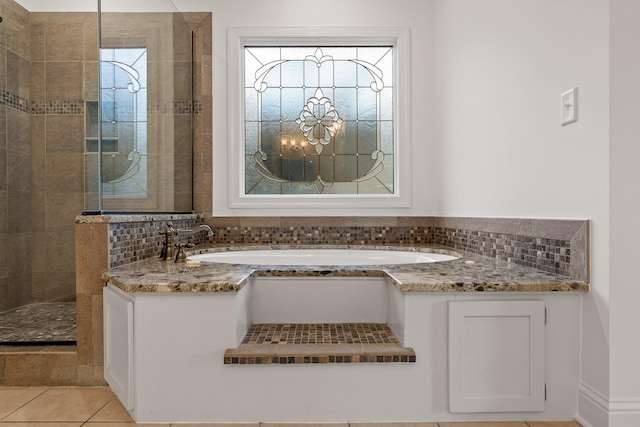 9539 Shadow Crossing Ln, Chattanooga, TN 37421 - bathroom featuring tiled shower, a bath, tasteful backsplash, and tile patterned flooring