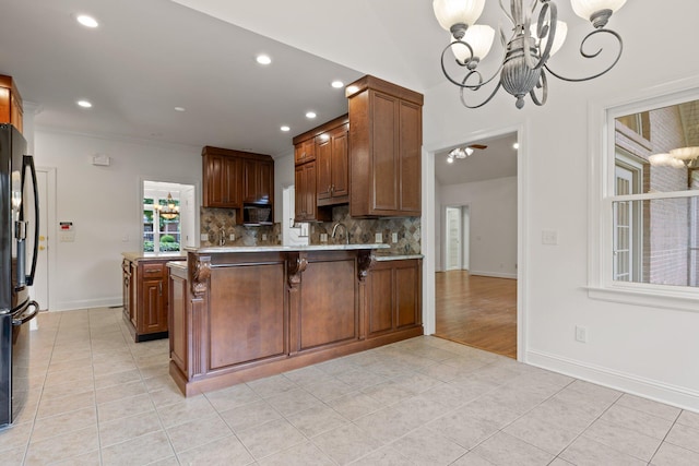 9539 Shadow Crossing Ln, Chattanooga, TN 37421 - kitchen featuring freestanding refrigerator, light tile patterned flooring, a chandelier, light countertops, and a peninsula